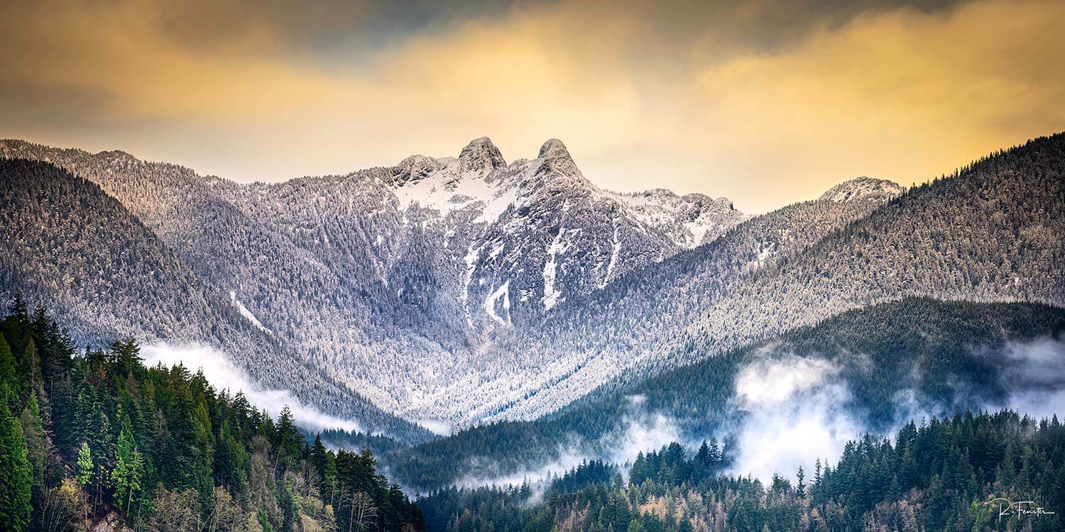 Majestic view of Vancouver's Lion's mountains, featuring a dusting of fresh snow.